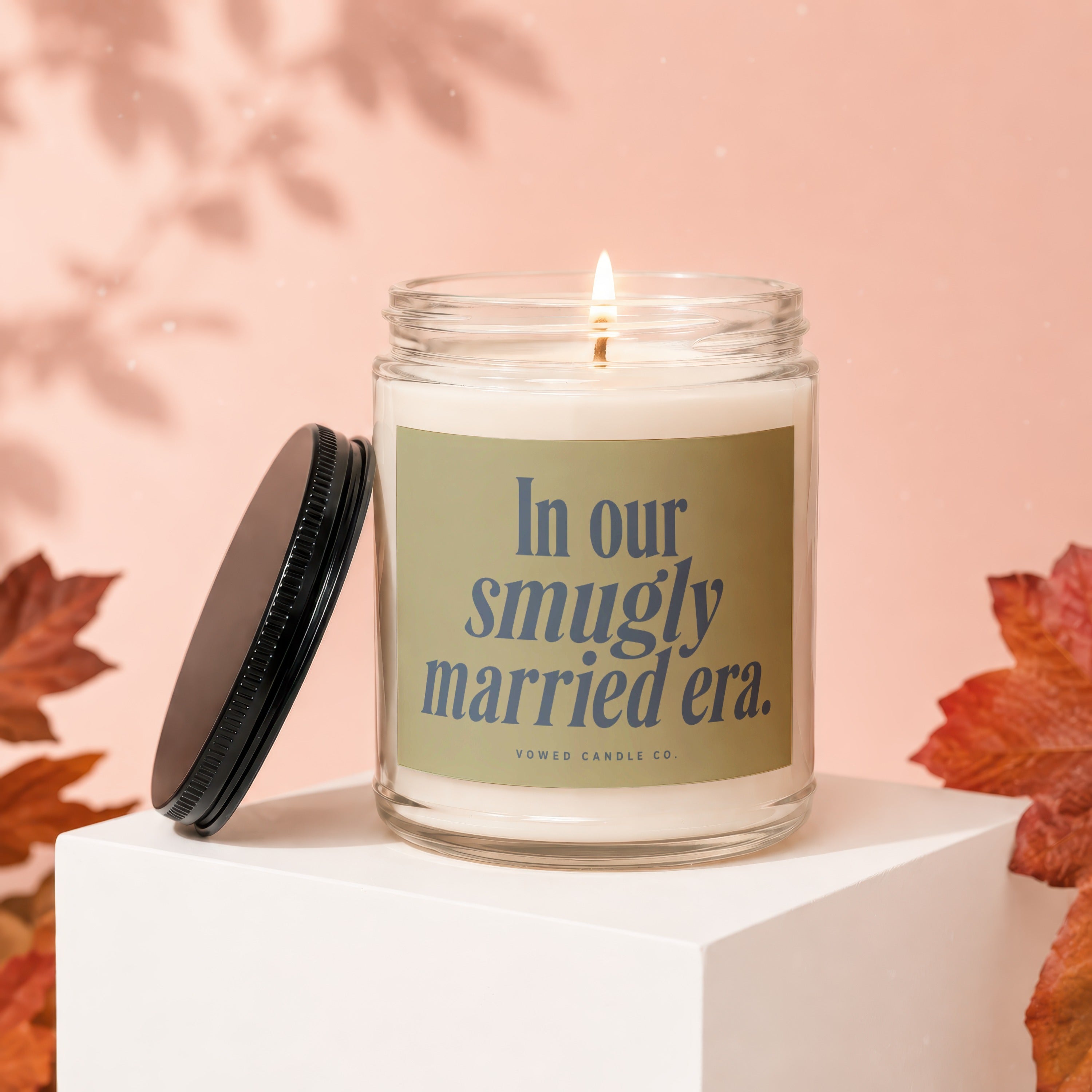 Candle on white cube with text "In our smugly married era."