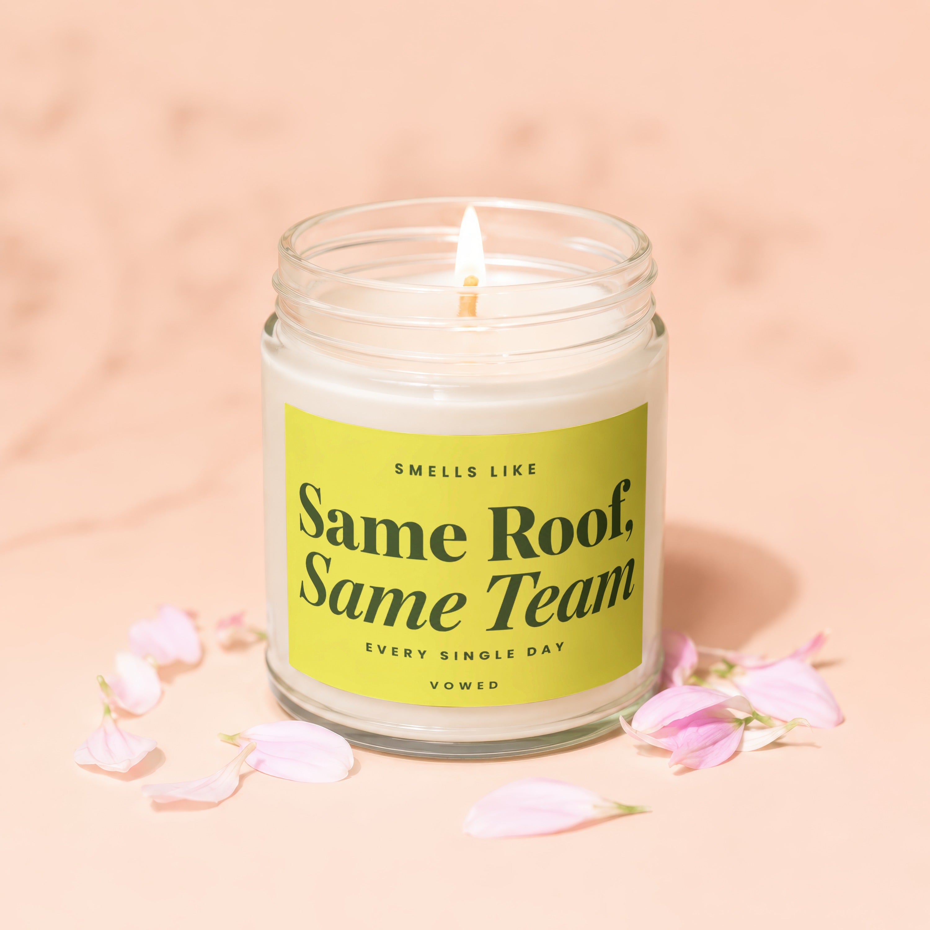 Candle with lime green label reading "Smells Like Same Roof, Same Team, Every Single Day, Vowed".