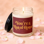 Lit candle with "You're a Man of Honor" text and petals.