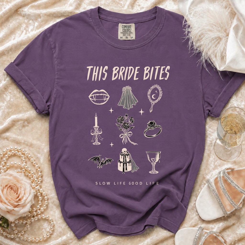 Purple t-shirt with "This Bride Bites" and gothic wedding illustrations.