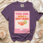 Purple t-shirt with "This Girl Needs a Spicy Marg" text graphic and margarita illustration.