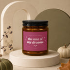 Amber glass candle with pink label reading "the man of my dreams. thank you for raising."