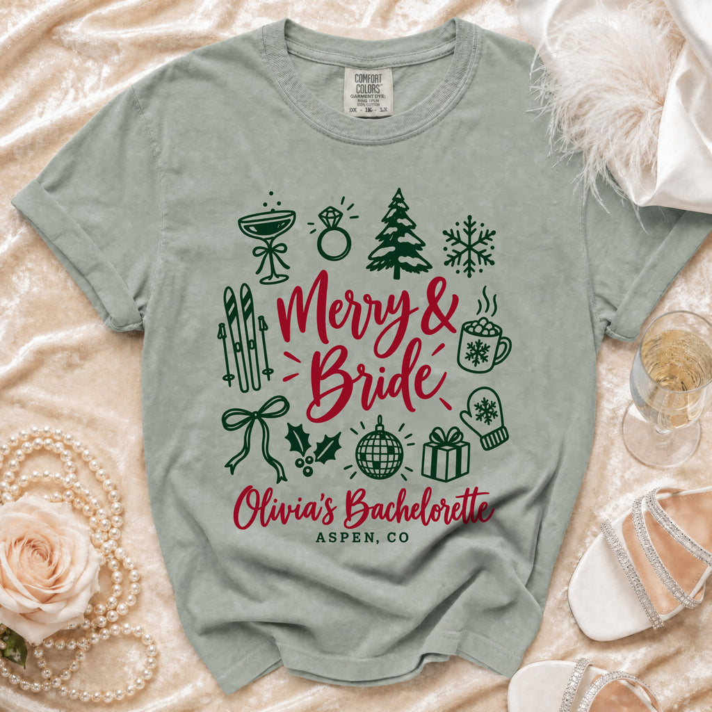 Green t-shirt with "Merry & Bride Olivia's Bachelorette Aspen, CO" and Christmas graphics.