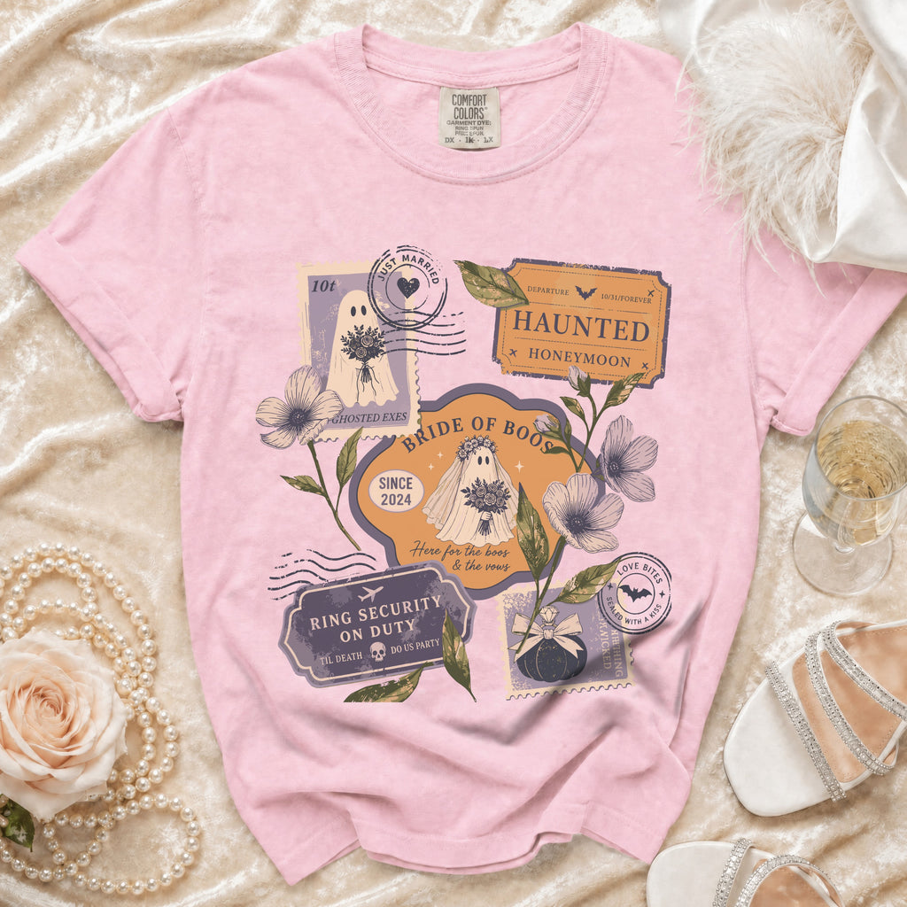 Pink t-shirt with "Bride of Boos" graphic featuring ghosts, postage stamps, and wedding-themed text.