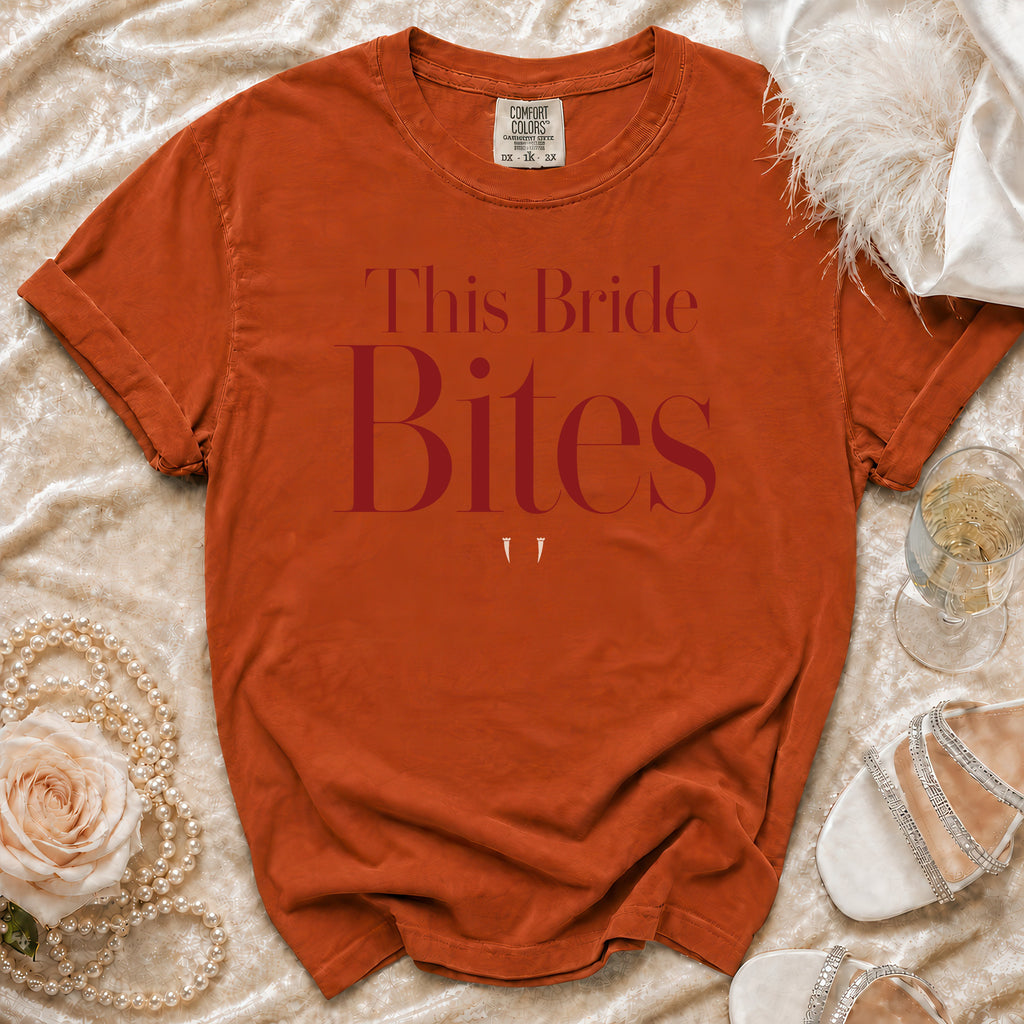 Orange t-shirt with "This Bride Bites" text and two small white fangs.