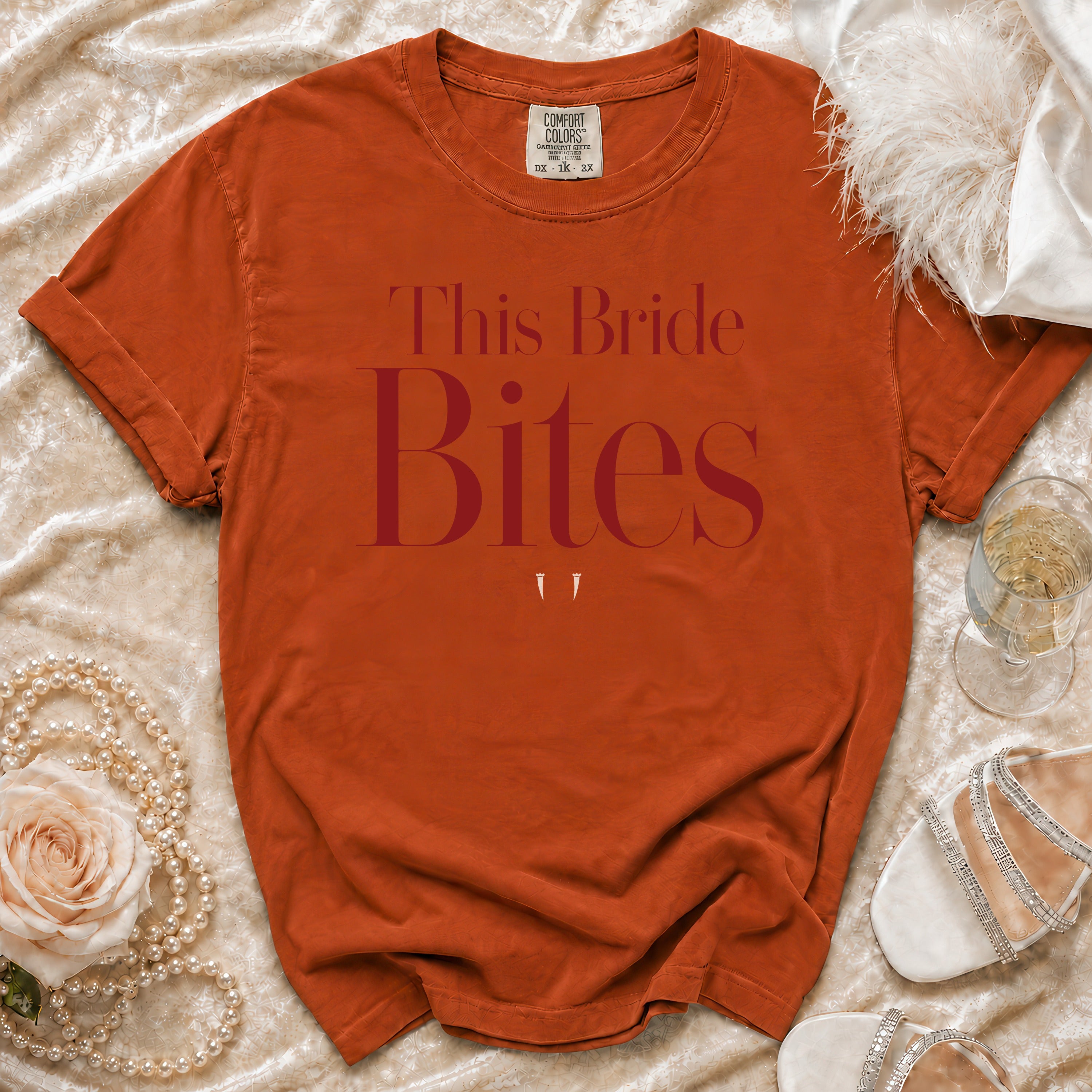 Orange t-shirt with "This Bride Bites" text and two small white fangs.
