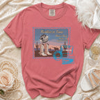 Distressed t-shirt with "Reckless in Texas" design featuring boots, disco ball, and desert scene.