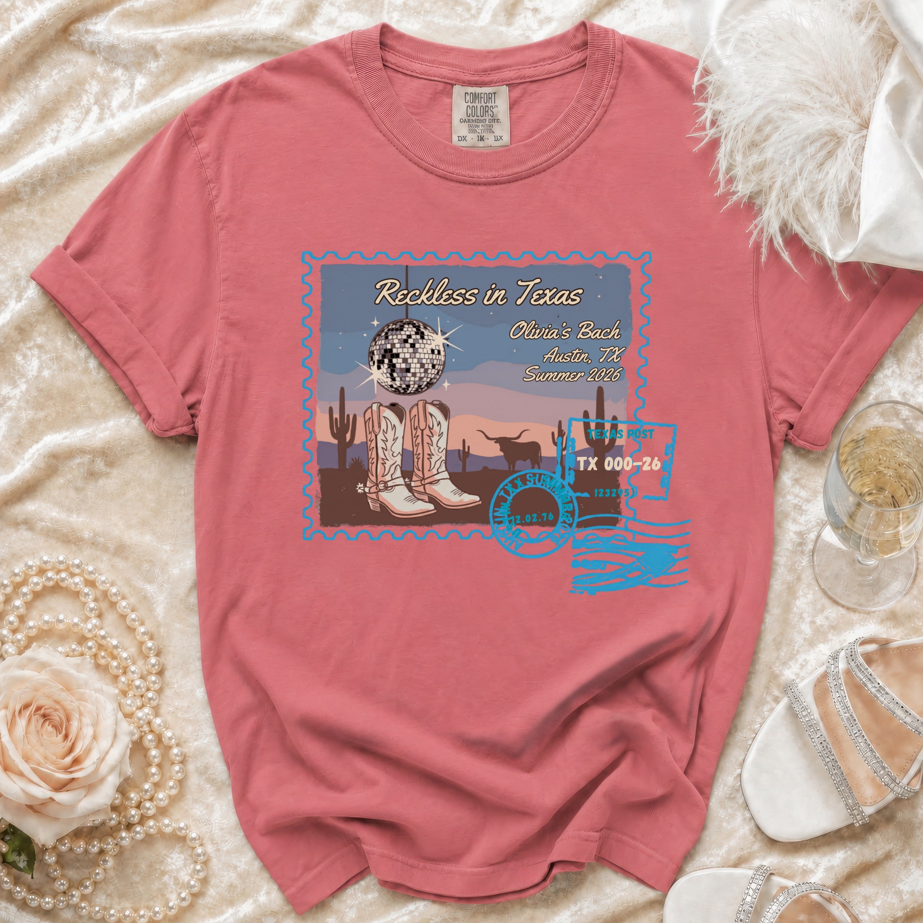 Distressed t-shirt with "Reckless in Texas" design featuring boots, disco ball, and desert scene.