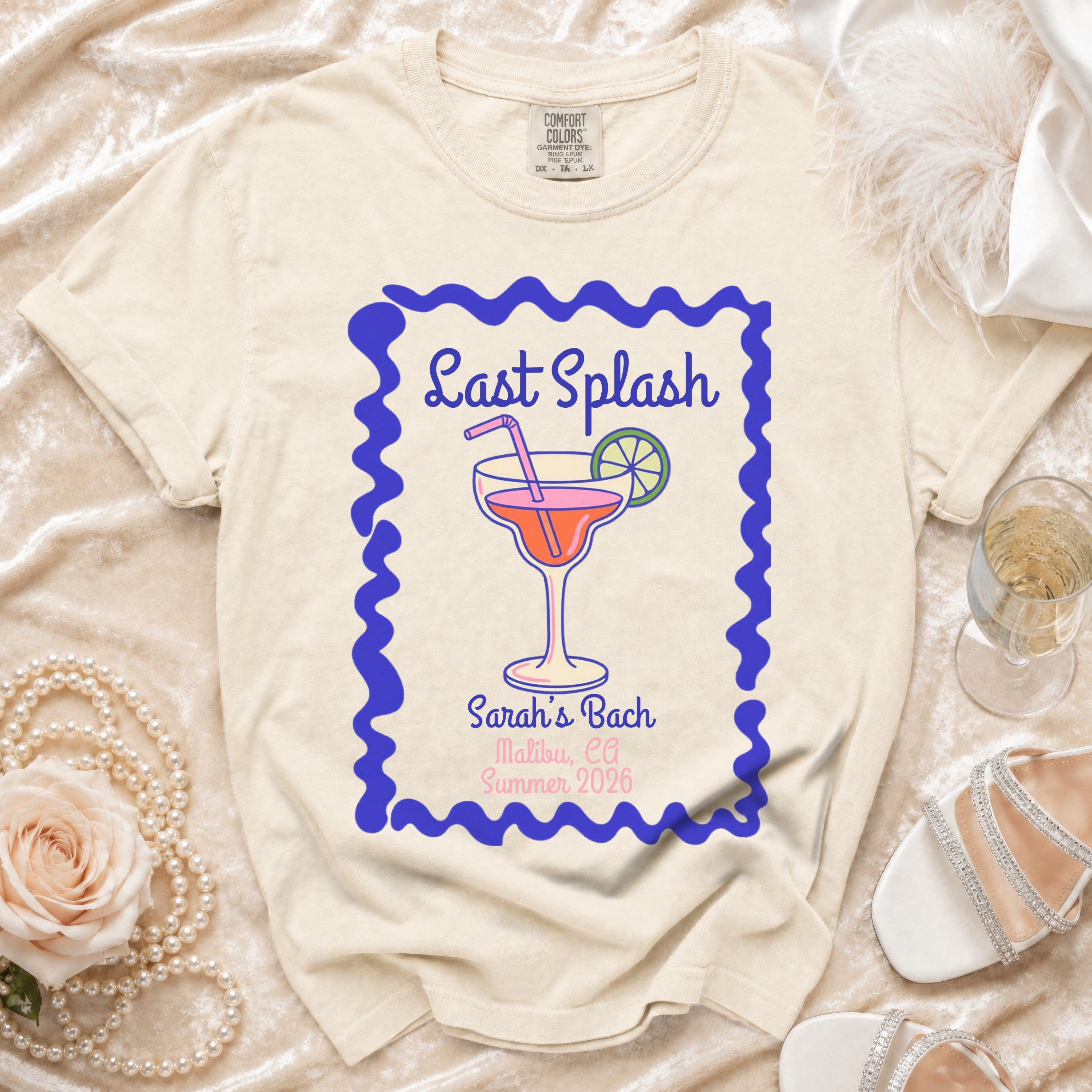 Cream t-shirt with blue border graphic, "Last Splash Sarah's Bach Malibu, CA Summer 2026".