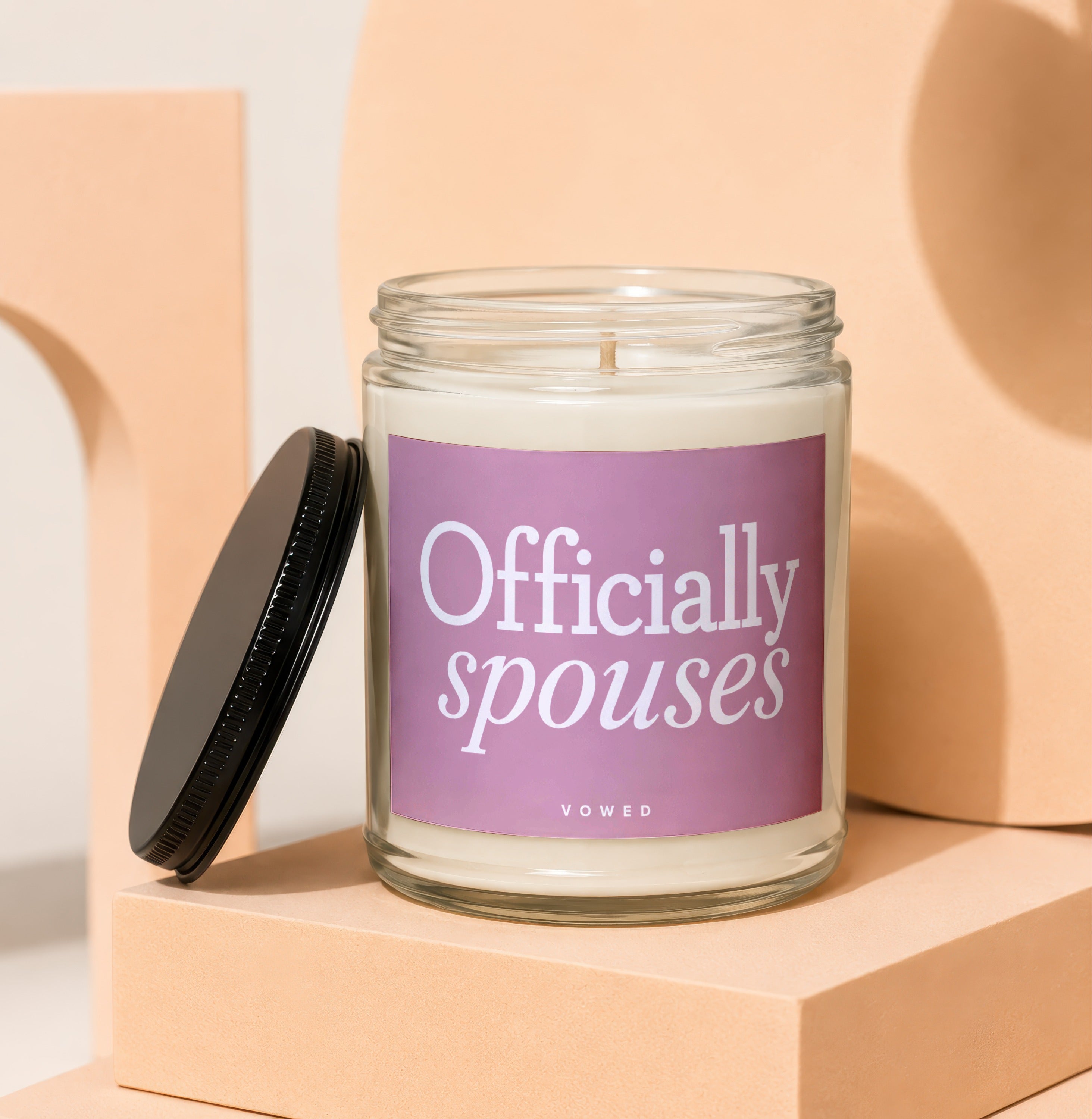 Glass candle with white wax and label reading "Officially spouses VOWED".