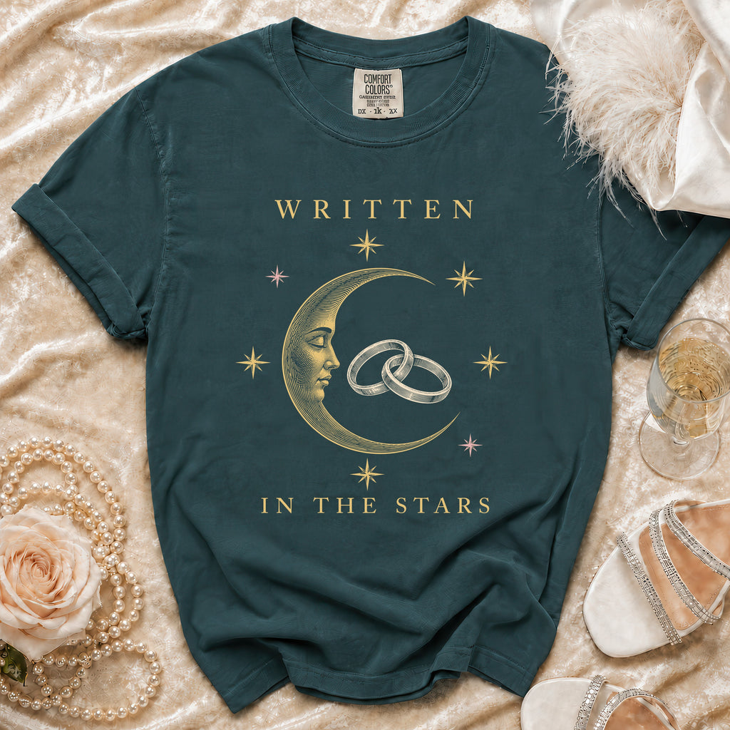 Teal t-shirt with crescent moon, rings, stars, and "WRITTEN IN THE STARS" text.