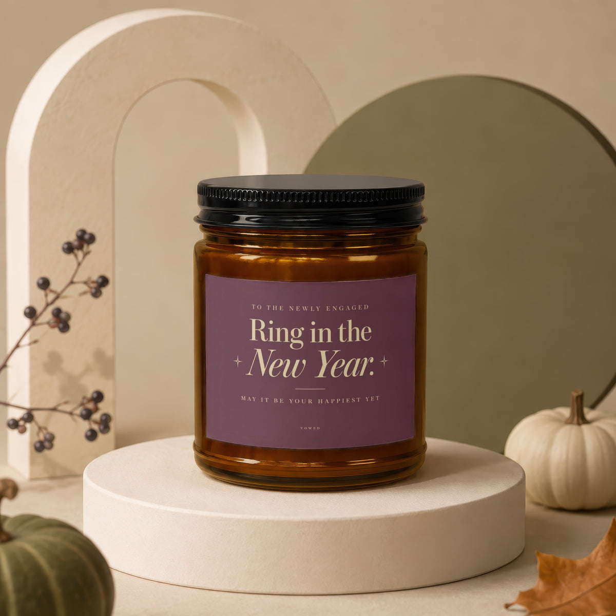 Candle with purple label reading "Ring in the New Year." and "May it be your happiest yet".