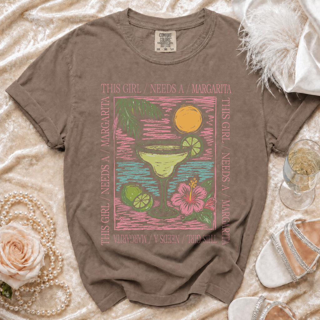 Brown t-shirt with "This Girl Needs A Margarita" text and a margarita graphic.
