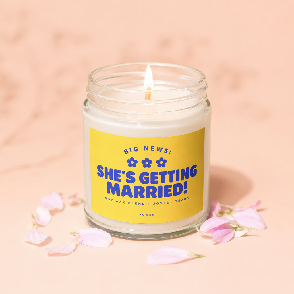 Candle with yellow label reading "BIG NEWS: SHE'S GETTING MARRIED!"