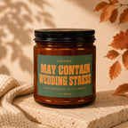 Amber candle with green label reading "CAUTION: MAY CONTAIN WEDDING STRESS" and "VOWED".