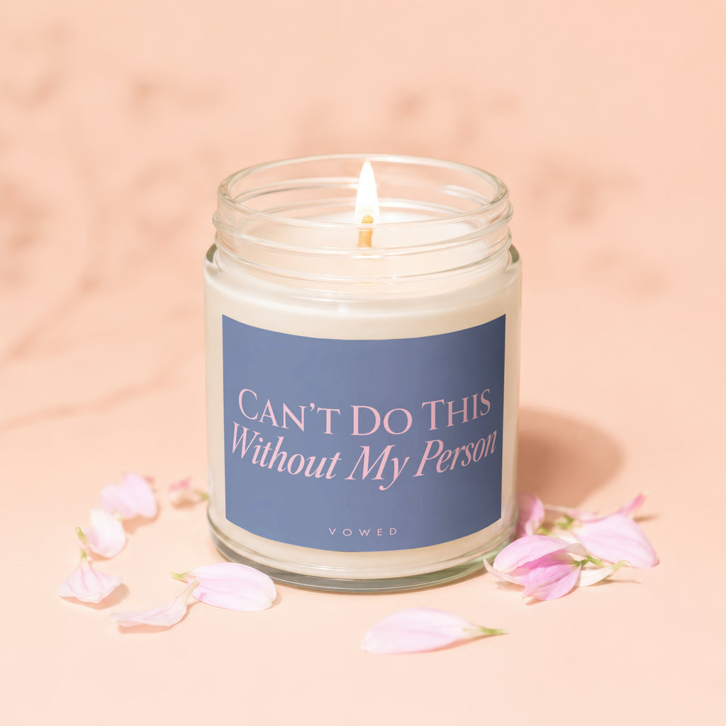 Candle with "CAN'T DO THIS Without My Person" text, surrounded by pink petals.