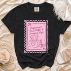 Black t-shirt with stamp graphic: "0¢ Professional Dress Fluffer & Emergency Cryer"