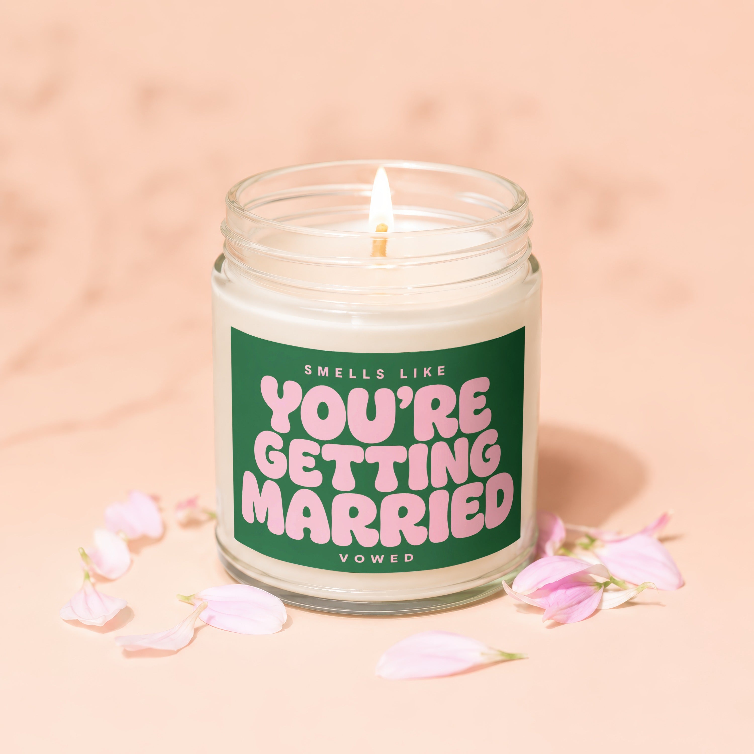 Glass jar candle with pink text "YOU'RE GETTING MARRIED" on a green label.