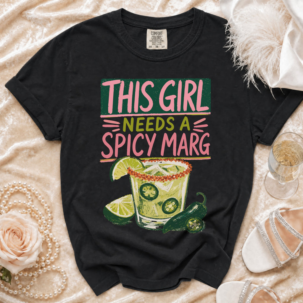 Black t-shirt with "This Girl Needs a Spicy Marg" text and margarita graphic.