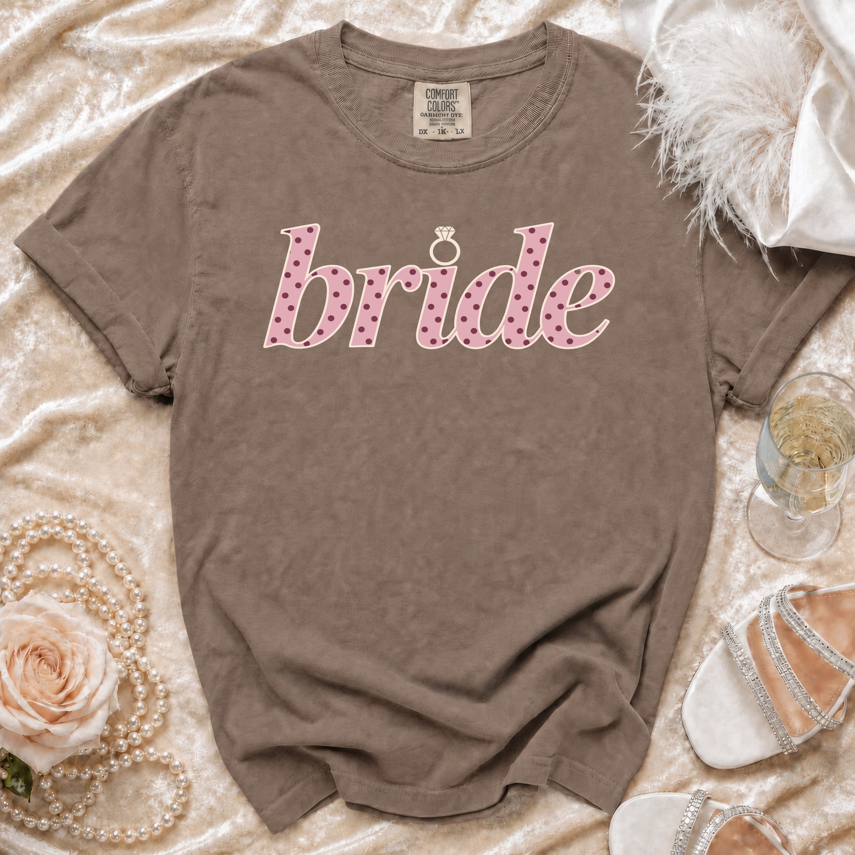 Brown t-shirt with "bride" in pink polka dots and a diamond ring graphic.