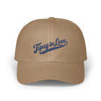 Tan baseball cap featuring blue embroidered cursive text that reads "Tipsy in Love" on the front.
