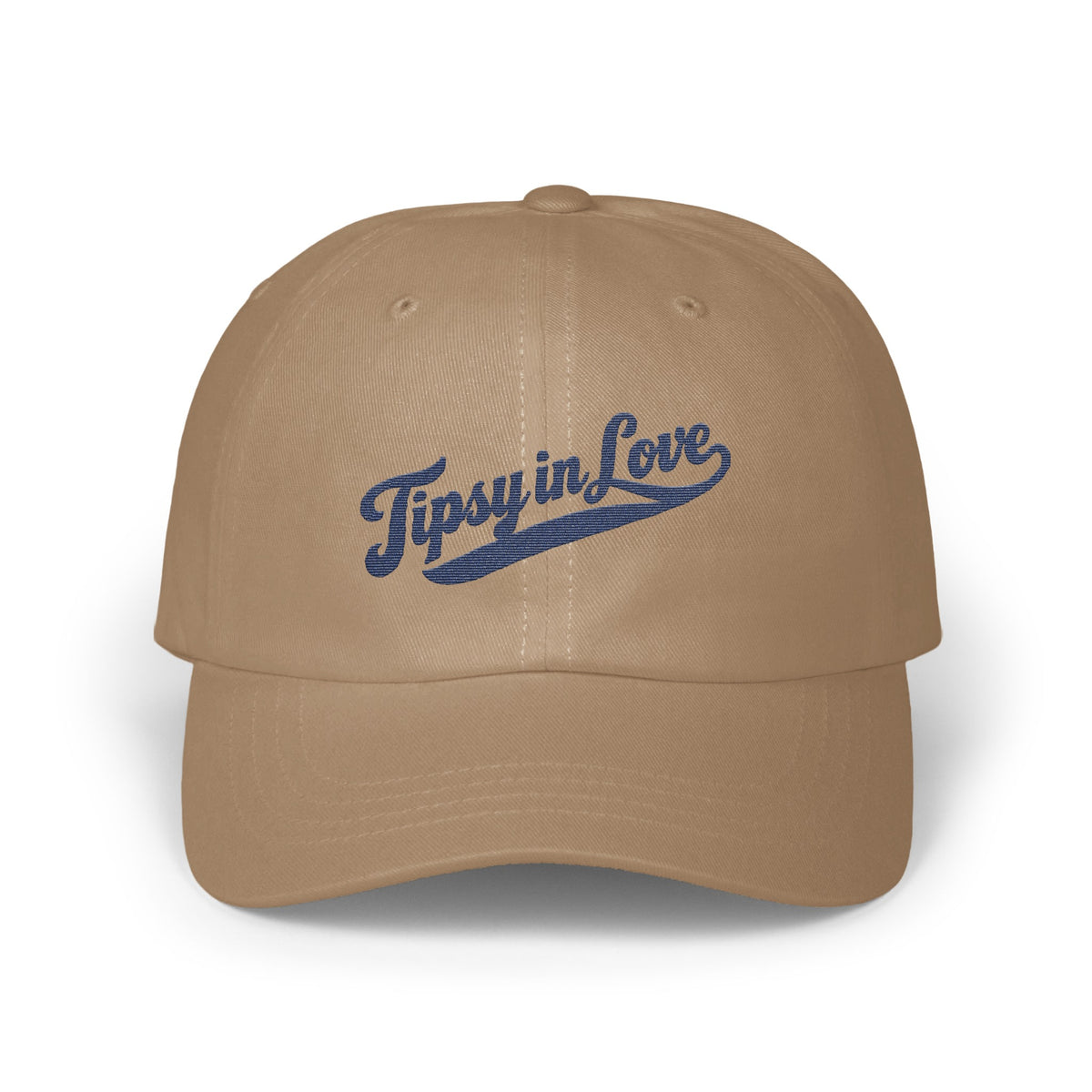 Tan baseball cap featuring blue embroidered cursive text that reads "Tipsy in Love" on the front.