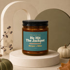 Amber candle labeled "He Hit The Jackpot" for Harper + Miles.