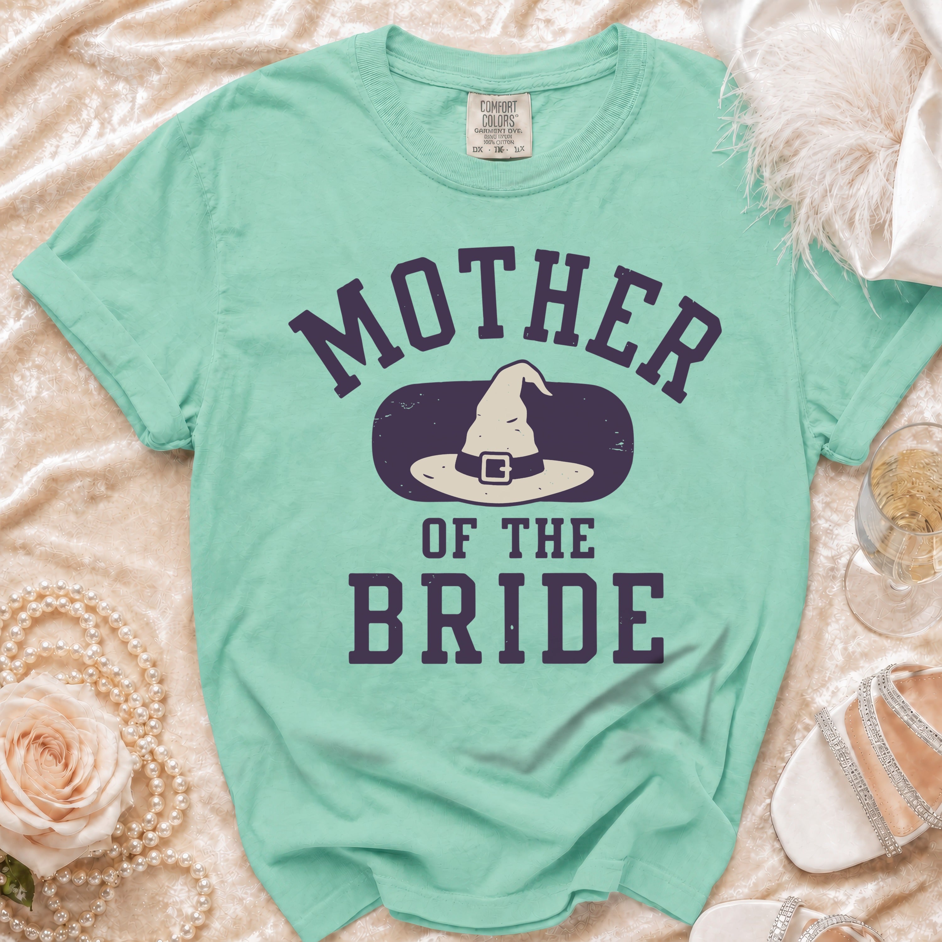 Mint green t-shirt with "Mother of the Bride" text and a witch hat graphic.