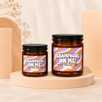 Two candles labeled "Champagne On Me! When You Say Yes!" on a beige display.