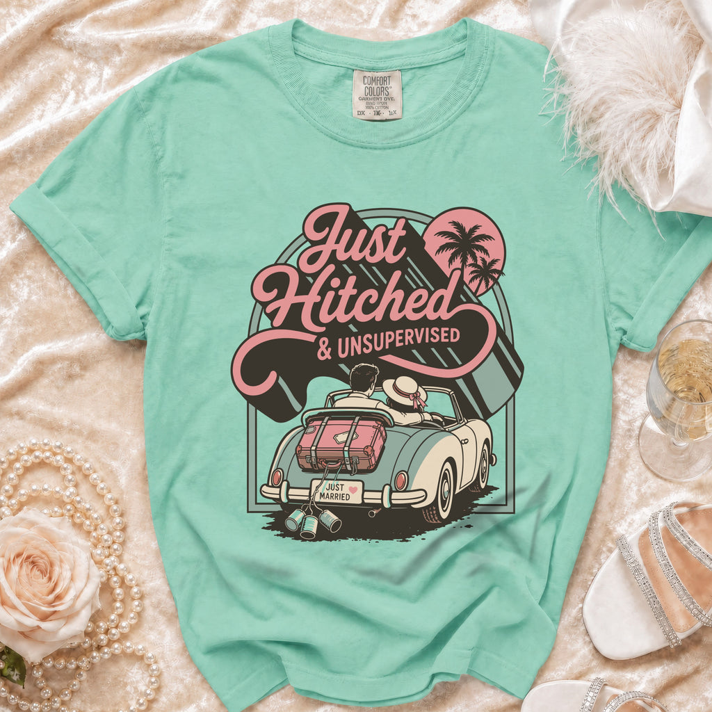 "Just Hitched & Unsupervised" graphic tee showing a couple in a convertible with luggage.