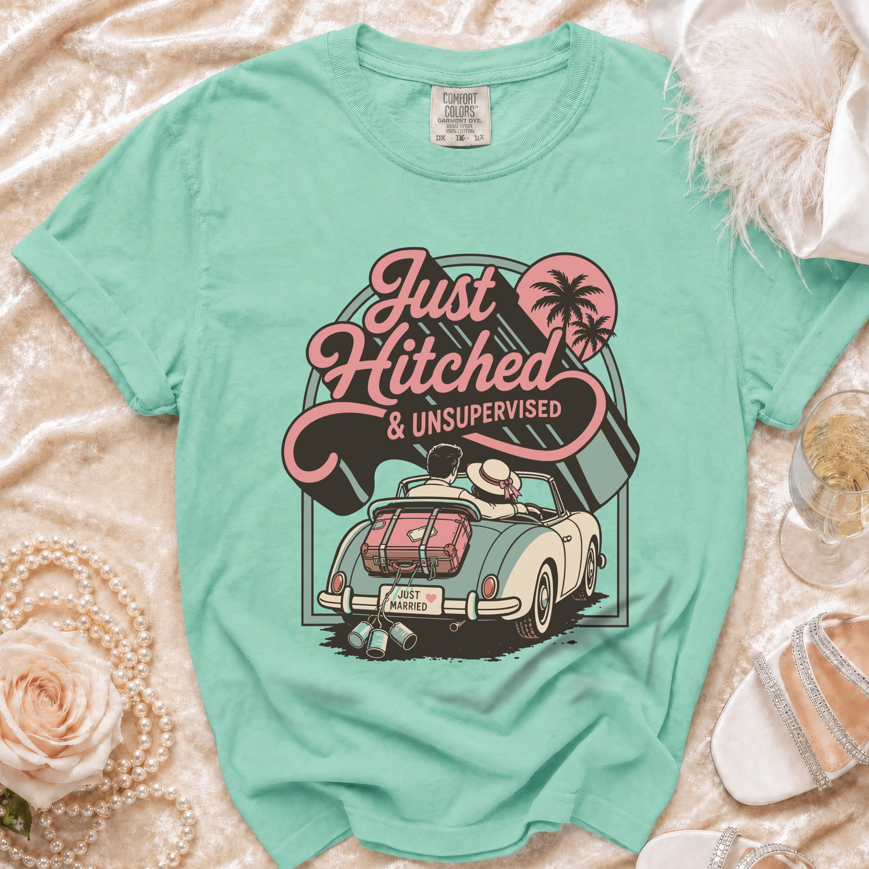 "Just Hitched & Unsupervised" graphic tee showing a couple in a convertible with luggage.