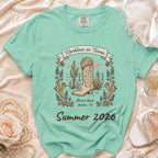 Green t-shirt with "Reckless in Texas" and cactus, boot, disco ball graphics.