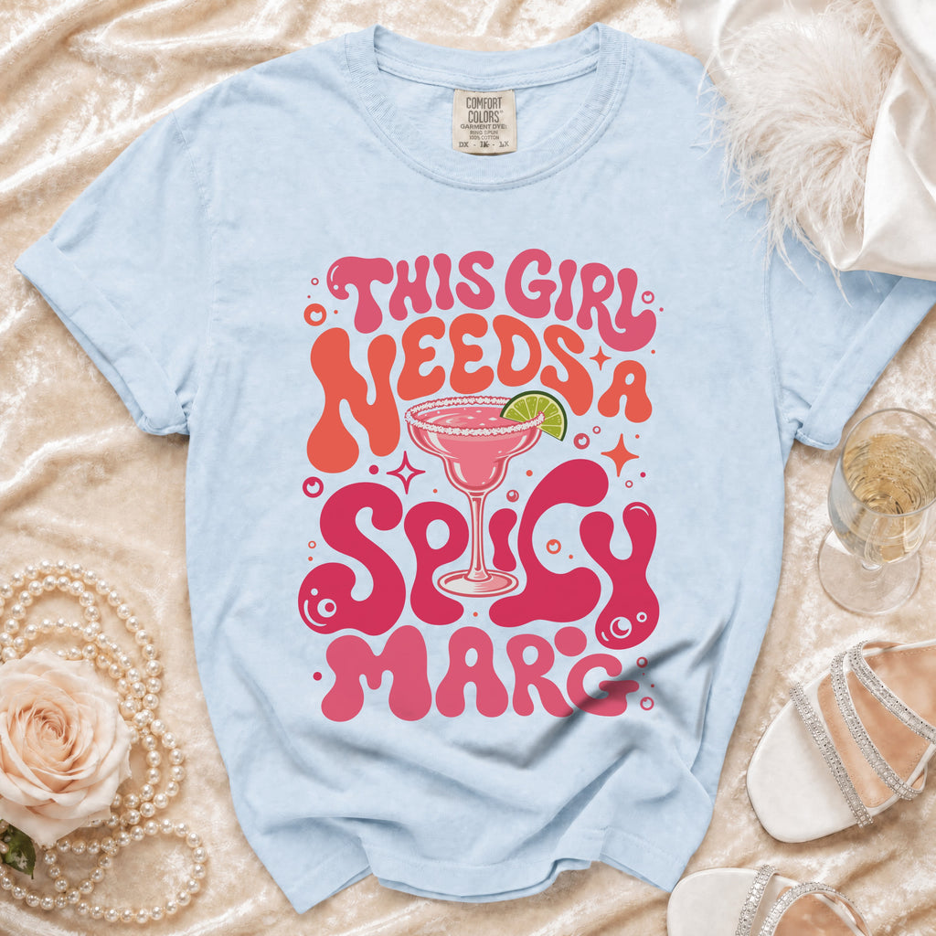 Light blue t-shirt with "This Girl Needs A Spicy Marc" text and margarita graphic.