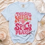 Light blue t-shirt with "This Girl Needs A Spicy Marc" text and margarita graphic.