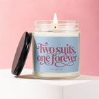 Candle with text "Two suits, one forever VOWED" on light blue label.