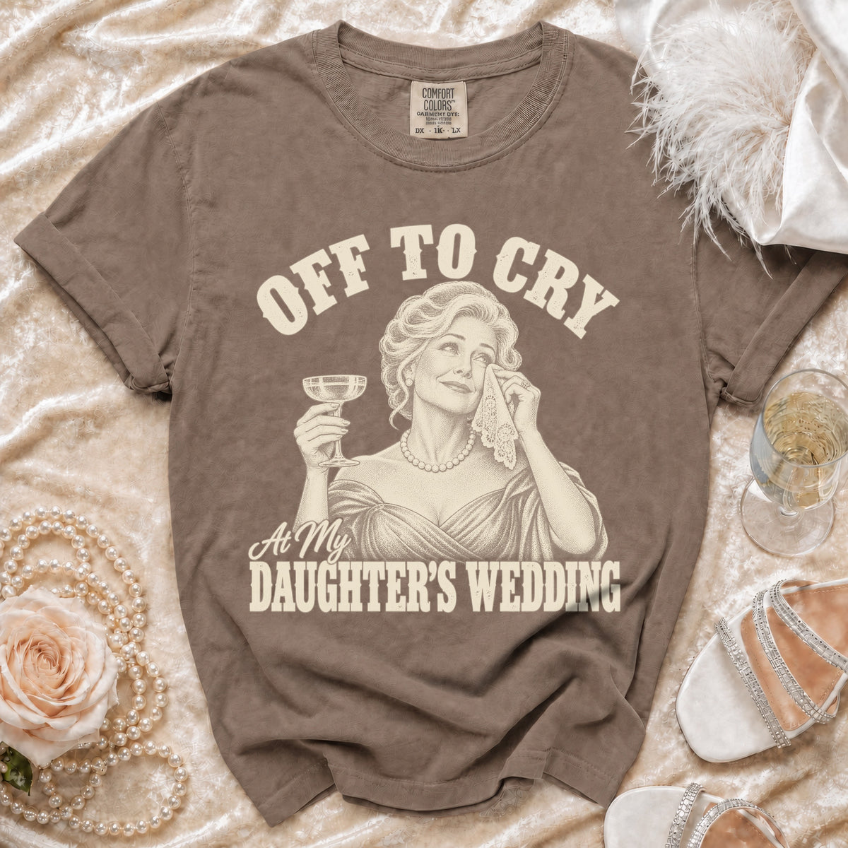 Brown t-shirt with "OFF TO CRY At My DAUGHTER'S WEDDING" text and illustration.