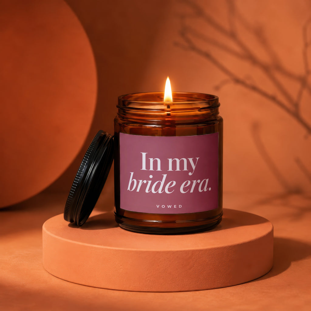 Amber jar candle with lit flame, reads "In my bride era."
