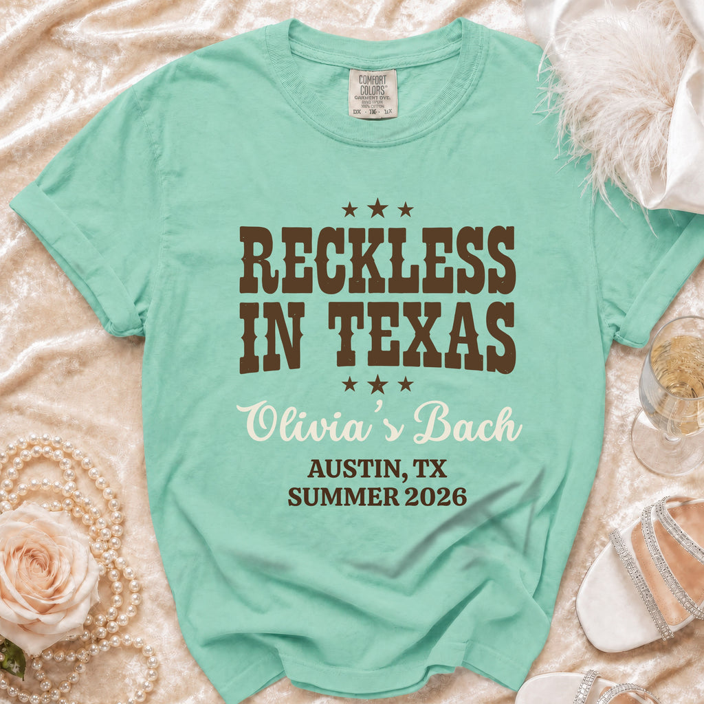 Teal Comfort Colors t-shirt with "Reckless in Texas Olivia's Bach" text.