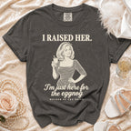 Charcoal gray t-shirt featuring the text I RAISED HER, an illustration of a woman drinking, and MOTHER OF THE BRIDE.
