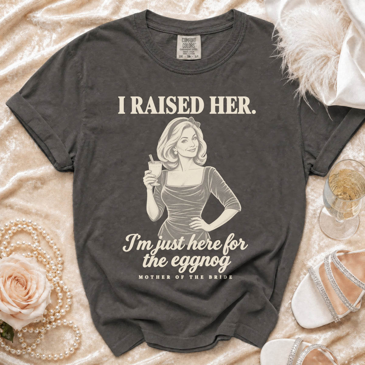 Charcoal gray t-shirt featuring the text I RAISED HER, an illustration of a woman drinking, and MOTHER OF THE BRIDE.