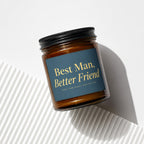 Amber jar candle with gold text on navy label that reads "Best Man, Better Friend".