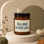 Amber jar candle with black lid, labeled "In my bride era."