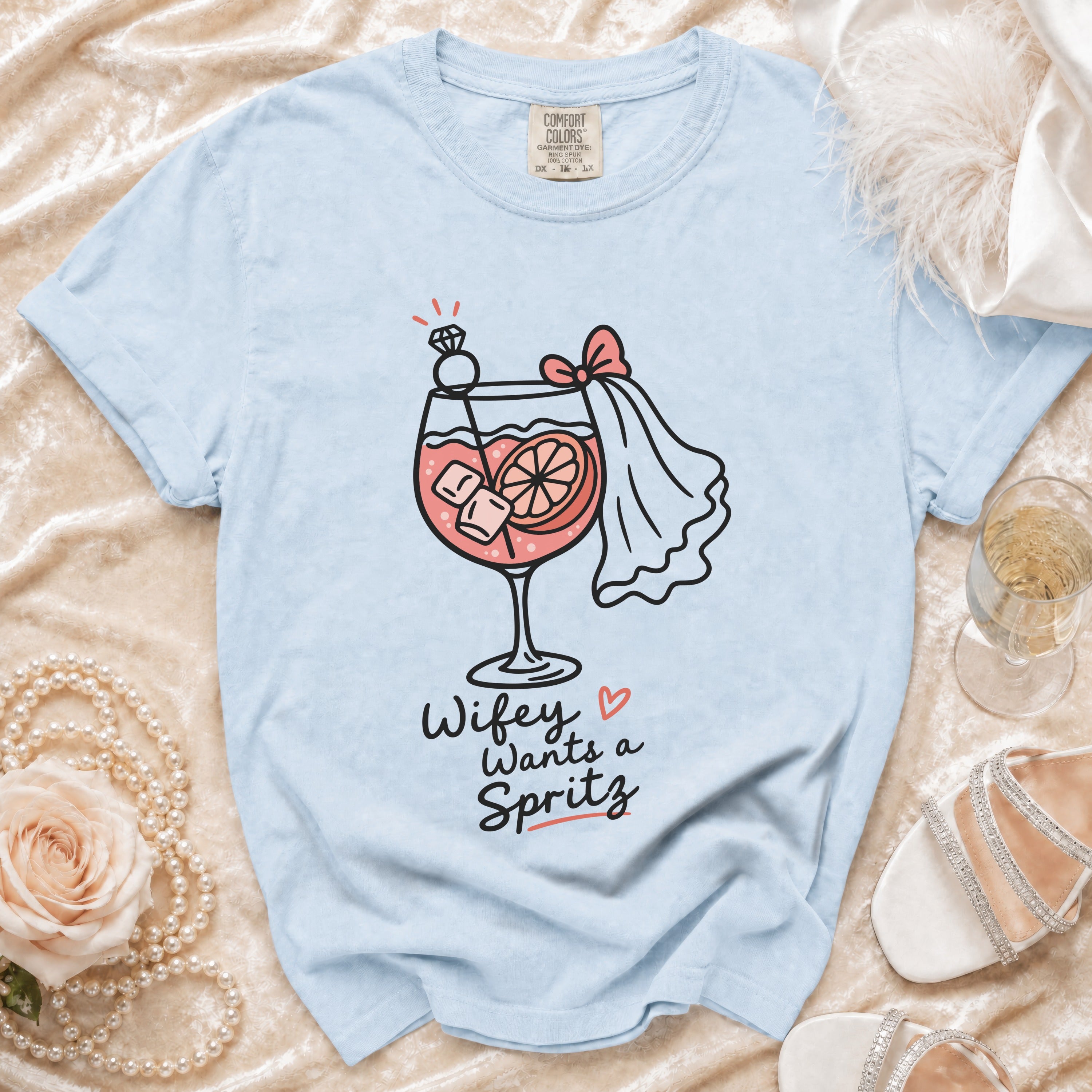 Light blue t-shirt with "Wifey Wants a Spritz" graphic of a cocktail.