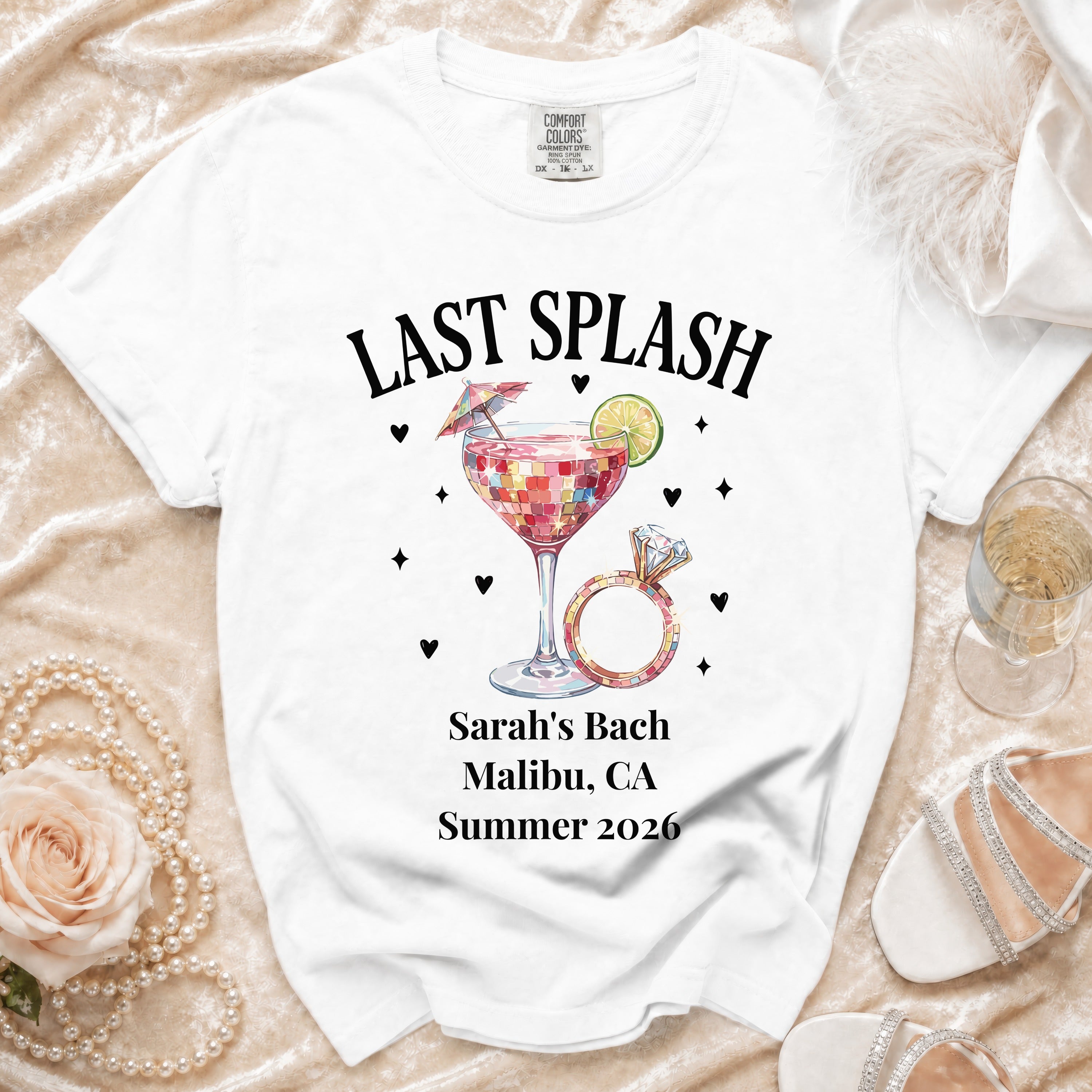 White t-shirt with "Last Splash" graphic, ring, and event details for Sarah's Bach.