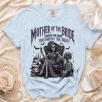 Light blue t-shirt with skeleton "Mother of the Bride" graphic and text.