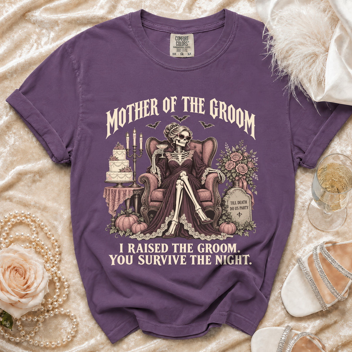 Purple t-shirt with "Mother of the Groom" skeleton graphic and "I Raised the Groom. You Survive the Night."