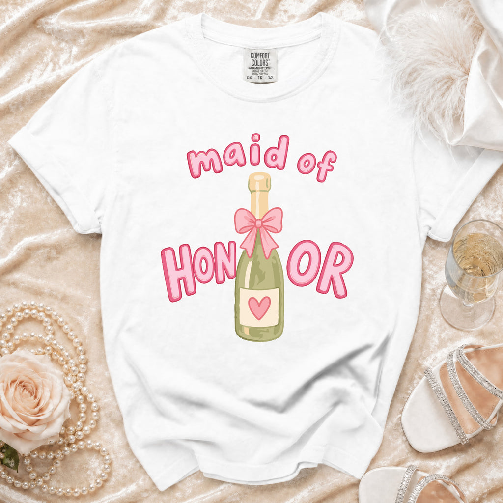 White t-shirt with "maid of HONOR" text and champagne bottle graphic.