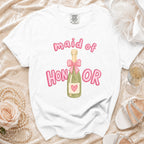 White t-shirt with "maid of HONOR" text and champagne bottle graphic.