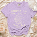 Purple t-shirt for Olivia's Bach in Austin, TX with cowboy boots and disco ball.