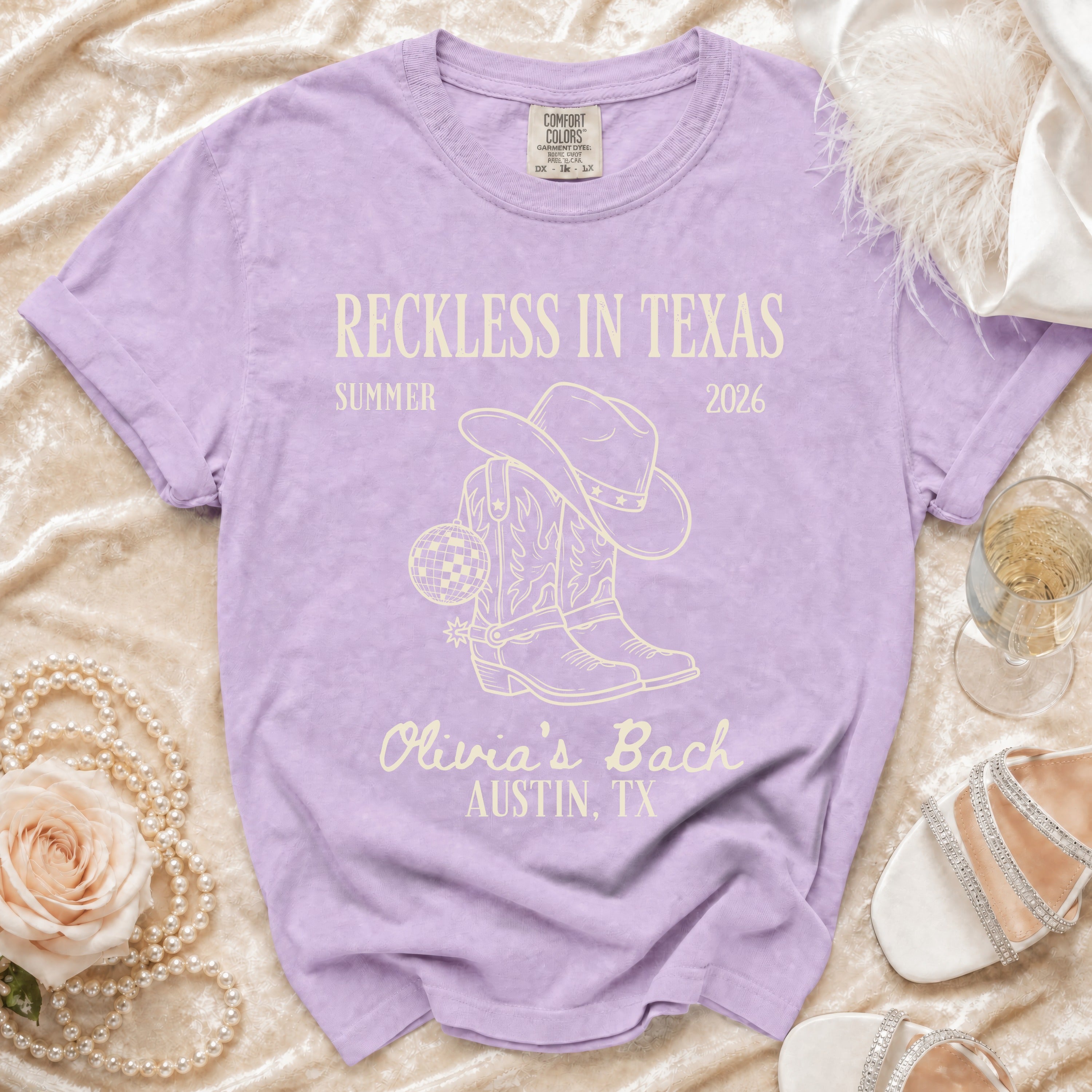 Purple t-shirt for Olivia's Bach in Austin, TX with cowboy boots and disco ball.